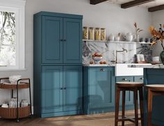 a kitchen with blue cabinets and marble counter tops on the wall, along with stools