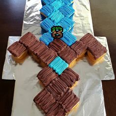 a cross made out of cupcakes sitting on top of a piece of tin foil