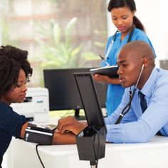 two doctors are looking at a computer screen