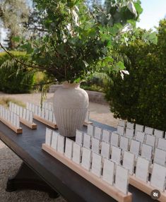 there is a white vase on top of a table with cards in front of it