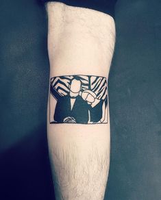 a man's leg with a tattoo on it that has an image of two people