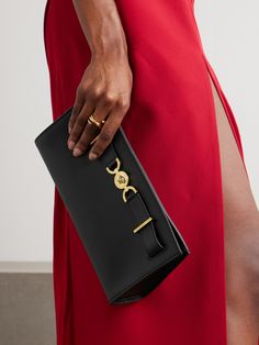 Versace’s sleek clutch is simply detailed with recognizable 'Medusa '95’ hardware. It’s crafted from leather and has a detachable chain strap so you can carry it crossbody, too. Stow smaller essentials inside, like your phone, wallet and keys. Elegant Leather Clutch With Palladium Hardware, Classic Clutch With Palladium Hardware, Classic Evening Clutch With Palladium Hardware, Formal Clutch Evening Bag With Metal Hardware, Luxury Evening Clutch With Metal Hardware, Luxury Clutch With Chain Strap For Night Out, Gold Clutch With Metal Hardware For Evening, Elegant Evening Clutch With Palladium Hardware, Timeless Clutch With Gold-tone Hardware