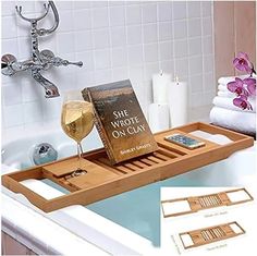 a bath tub with a wine glass and book on it