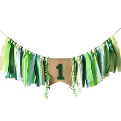 a banner with the number one hanging from it's side and tassels