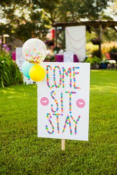 a sign that says one step at a time with balloons and confetti on it