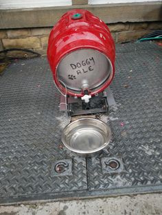 a red propaner sitting on top of a metal floor