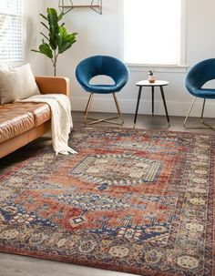 a living room with two chairs and a rug