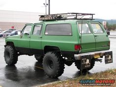 a large green truck parked in a parking lot