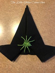 an origami star with green thread on it sitting on top of a table