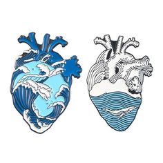 two blue and white heart shaped brooches sitting next to each other on a white surface