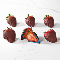 chocolate covered strawberries are arranged in the shape of a heart on a white surface