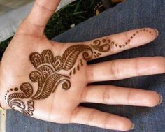 a person's hand with a henna on it