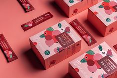 six boxes with different designs on them sitting on a pink surface next to each other