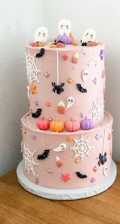 a three tiered cake decorated with halloween decorations