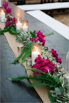 a long table with flowers and candles on it