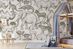 a child's bedroom with an animal wallpaper