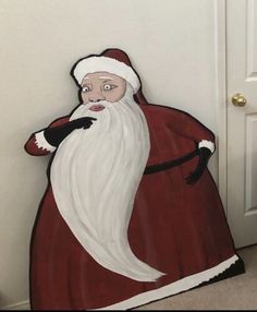 a cardboard santa clause standing in front of a door