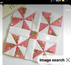 a pink and white patchwork quilt on a table with the words image search below it