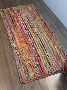 a multicolored rug on the floor next to a ball