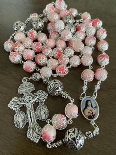 "This beautiful handmade rosary is made with 10mm pink stone,silver plated beads, 2\" Pardon crucifix.   Length: 28\" inches long" Pink Spiritual Jewelry With 8mm Beads, Handmade Pink Rosary With Round Beads, Pink Beaded Spiritual Rosary, Pink Rosary With Miraculous Medal As A Gift, Pink Rosary With 8mm Round Beads, Pink Rosary With 8mm Beads For Gift, Pink Rosary With 8mm Beads As Gift, Pink Beaded Rosary With Round Beads, Handmade Pink Spiritual Rosary