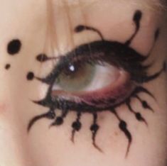 a woman's eye with black ink on her face and the words scum - bucket