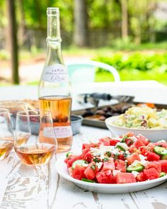 watermelon salad and wine on an outdoor table