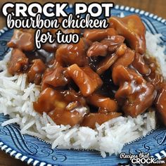 a blue and white plate topped with rice covered in gravy