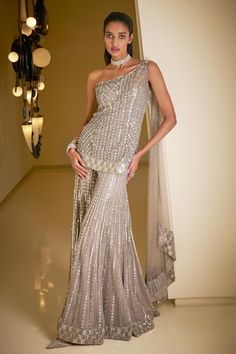 Silver one shoulder kurta featuring sequin and crystal embellished stripe patterns along with attached dupatta. Comes with sequin embroidered sharara. - Aza Fashions Grey Wedding Dress Silver, Grey Sharara, Sequin Sharara, Guest Wardrobe, Sequins Suit, Indian Reception Outfit, Indian Fits, Sequin Lehenga, Seema Gujral