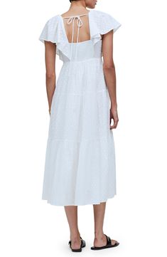 This ever-enchanting cotton maxi is designed with fluttering sleeves and a flouncy tiered skirt. 50" length (size 8) Adjustable back tie closure V-neck Short sleeves Lined 100% cotton Machine wash, tumble dry Imported White Maxi Dress With Flutter Sleeve And Ruffle Hem, Elegant Tiered Cotton Midi Dress, Tiered Cotton Maxi Dress With Ruffle Hem, Ruffle Sleeve Maxi Dress For Daywear, Maxi Length Tiered Dress With Ruffles For Daywear, Feminine Cotton Maxi Dress With Ruffles, Feminine Tiered Cotton Midi Dress, Cotton Tiered Dress With Flutter Sleeves And Ruffles, Cotton Midi Dress With Flutter Sleeves For Brunch