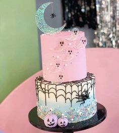 a three tiered cake decorated with spooky decorations