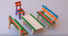 three miniature wooden chairs made to look like children's beach chairs with colored slats