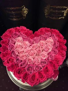 a heart shaped box filled with pink roses