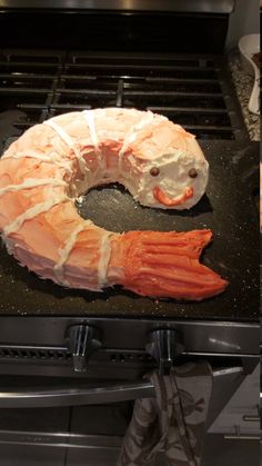 a large shrimp cake sitting on top of an oven