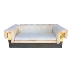 a white couch sitting on top of a wooden table