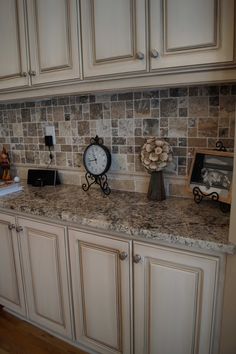 a kitchen counter with a clock and other items on it's side, in the middle of an instagram