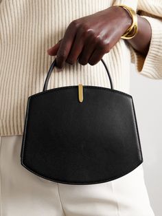 Savette's 'Florence' tote is aptly named after the Italian fashion capital renowned for its quality materials and expert craftsmanship. Made from smooth leather, it's designed in a contemporary, structured shape with a rounded base and sleek gold-tone embellishment. Forego your wallet and instead stow your cards in the internal slot, creating more room for your phone and cosmetics. Elegant Structured Shoulder Bag With Smooth Grain, Elegant Structured Bag For Formal Occasions, Elegant Shoulder Bag With Dust Bag And Round Handle, Elegant Structured Formal Bag, Luxury Bags With Smooth Grain And Round Handle, Luxury Bag With Smooth Grain And Round Handle, Formal Shoulder Bag With Round Handle, Elegant Black Shoulder Bag With Smooth Grain, Elegant Everyday Luxury Handheld Shoulder Bag