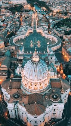 an aerial view of a city with buildings and streets at night, including the dome of st peter's cathedral