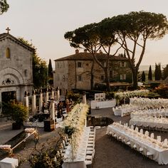 an outdoor wedding venue with tables and chairs set up for the guests to sit down