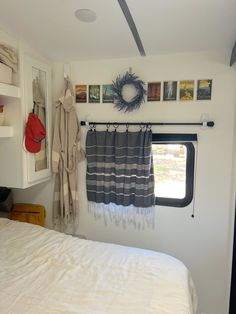 there is a bedroom with a bed and pictures on the wall above it, along with other items