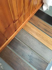 wood flooring is being installed on the side of a door and under a cabinet