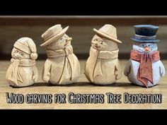 wooden carving for christmas tree decoration featuring three snowmen with hats and scarfs on their heads