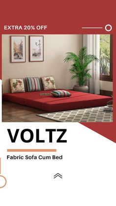 a living room with a red couch and pictures on the wall above it that says voltz fabric sofa cum bed extra 20 % off