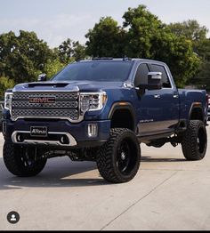 a large blue truck parked in a parking lot