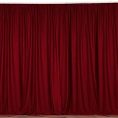 a red curtain is open in front of a white wall