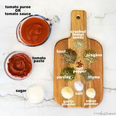 ingredients to make homemade barbecue sauce on a cutting board with spices and seasonings labeled