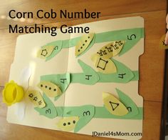 the corn cob number matching game is made with paper and scissors to make it