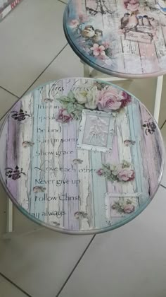 two tables that have flowers on them with words painted on the table top and bottom