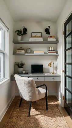 a white chair sitting in front of a computer on top of a desk next to a window