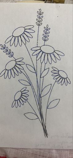 a drawing of some flowers on a piece of paper