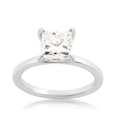 a princess cut diamond engagement ring in white gold with a square center stone on the band